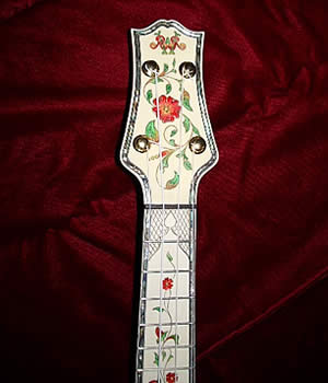 A close up of the fingerboard of an intricate, one-of-a-kind Randy
            Wood ukulele that's for sale:  